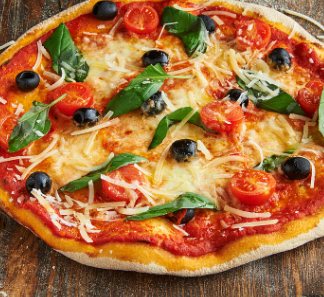 Freshly baked pizza topped with cherry tomatoes, olives, basil and mozzarella